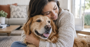 Person gently hugging a dog while observing the dog’s body language